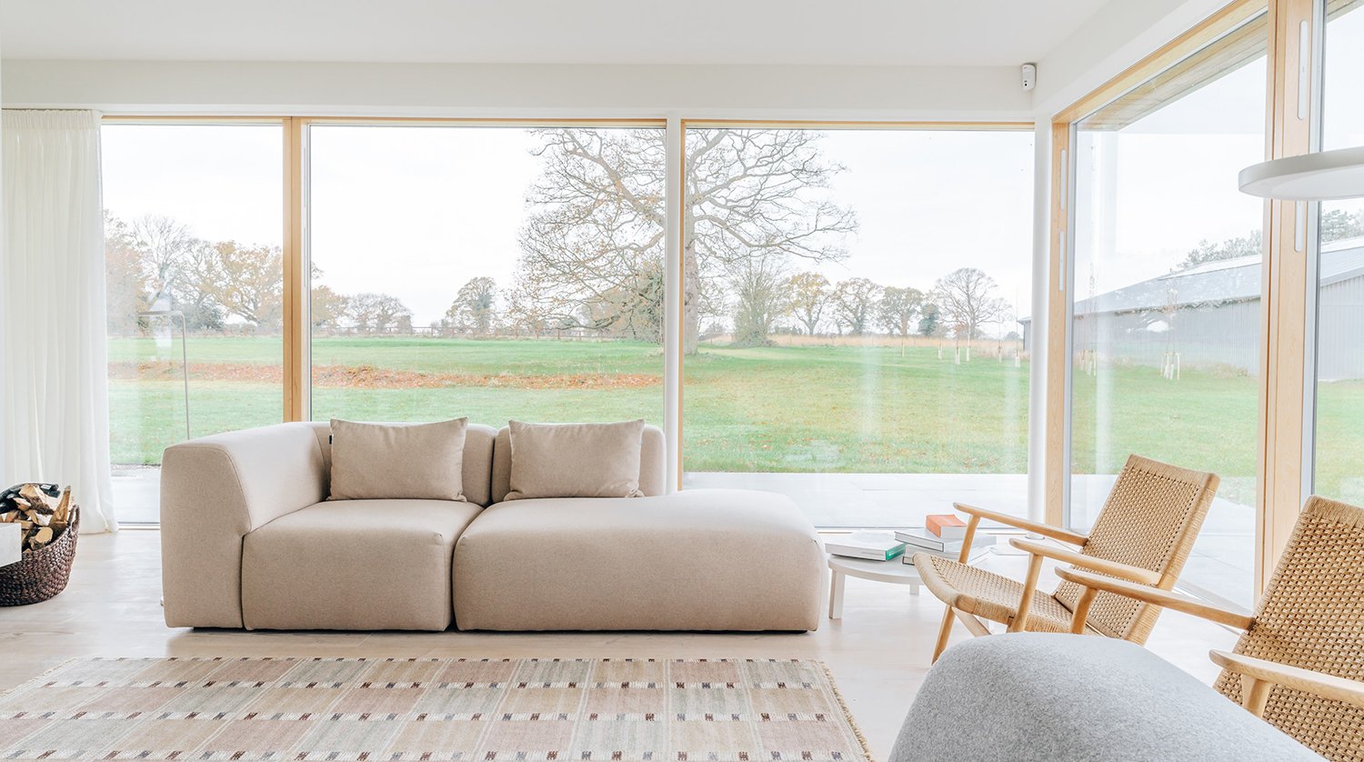 Contemporary interior with sofa and views over open fields