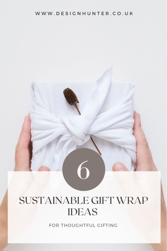 Minimalist sustainable gift wrapping featuring a fabric wrap and dried flower detail, perfect for eco-friendly gifting.